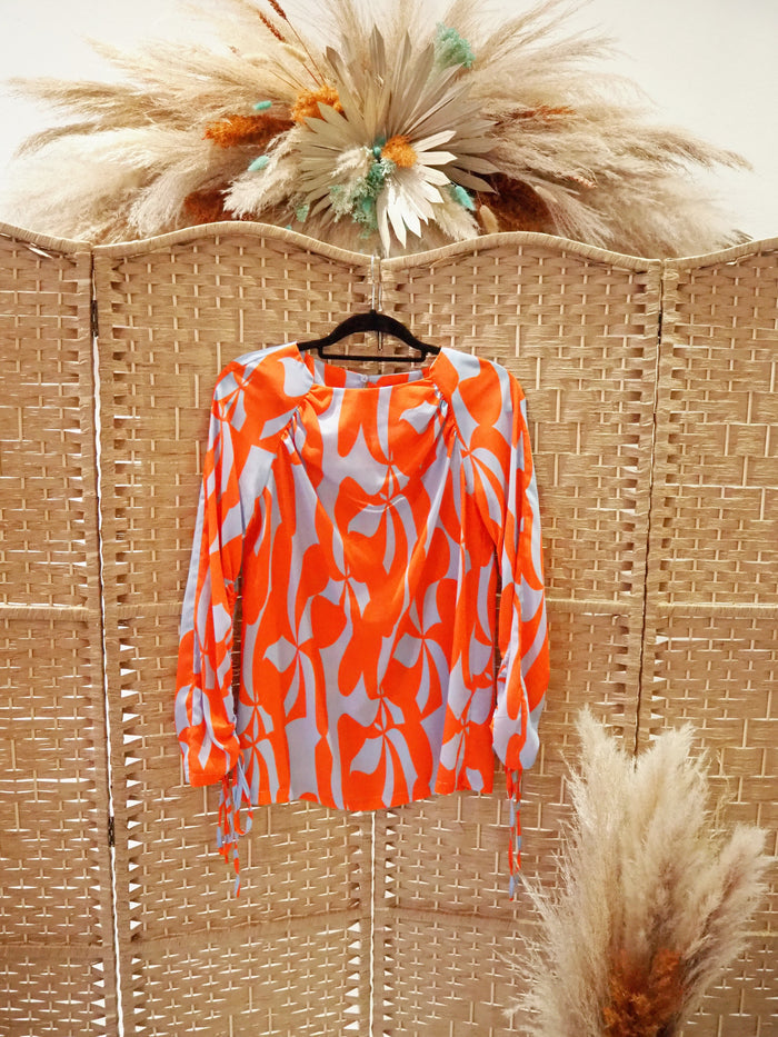 Lennon Courtney at Dunnes Orange/Blue blouse 10