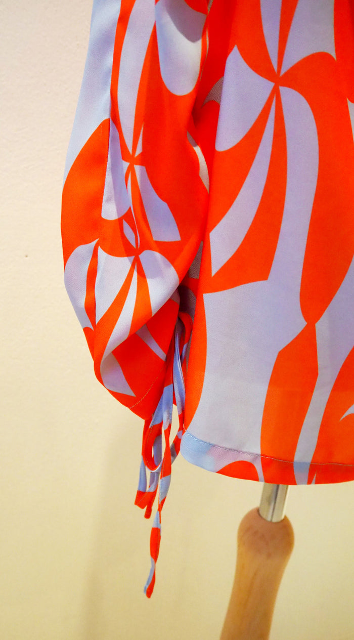 Lennon Courtney at Dunnes Orange/Blue blouse 10