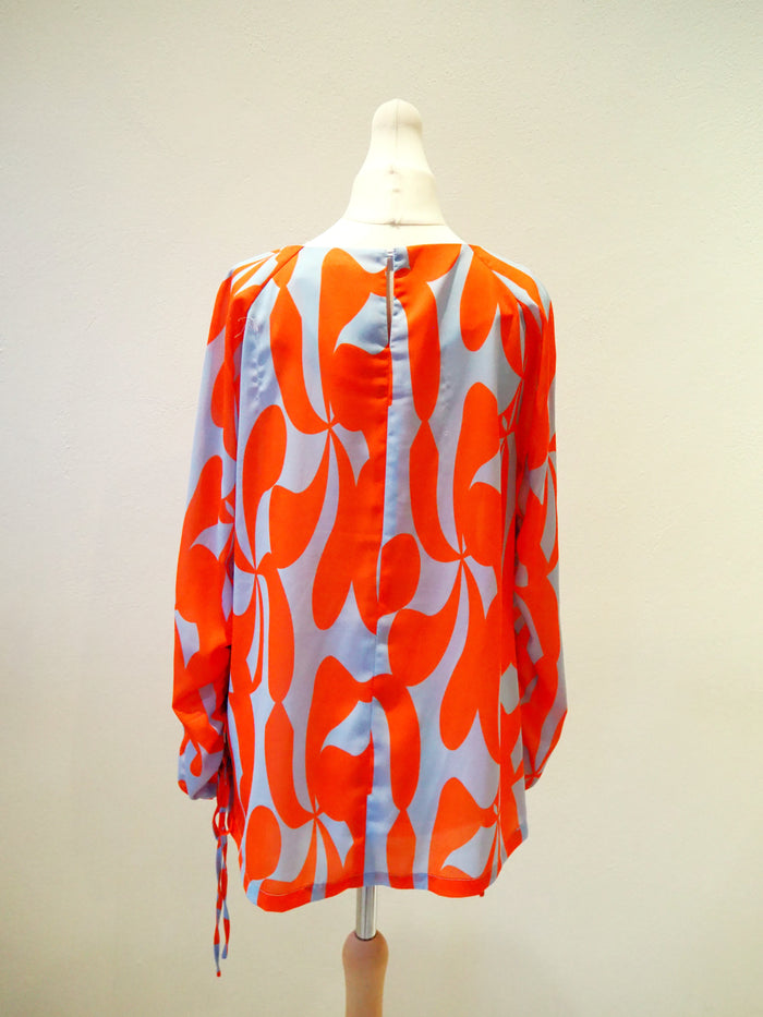 Lennon Courtney at Dunnes Orange/Blue blouse 10