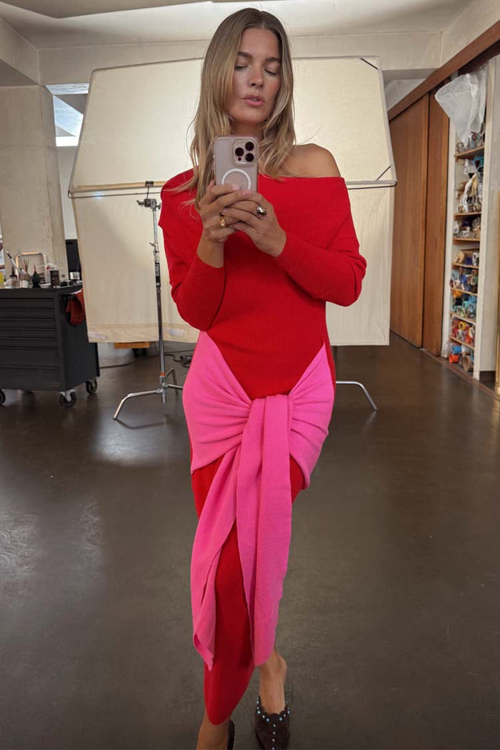 Red and pink Afia midi dress with a multi-wear wrap tie waist and off-the-shoulder style in a mirror selfie.