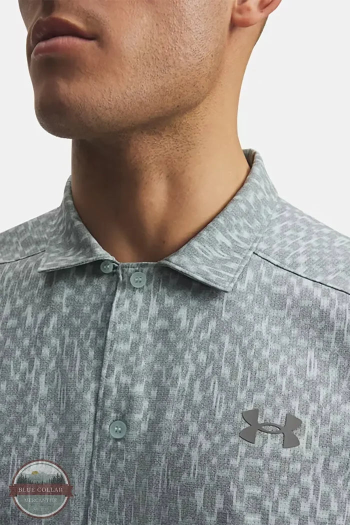 Under Armour 6009180-477 UA Explor Airvent Woven Men's Short Sleeve Shirt in Enamel Blue/Clay Green close up of front branding on shirt